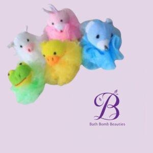 Rainbow duck shaped bath bombs in pastel colors connected in a line with bath bomb beauties logo nearby on a light purple background