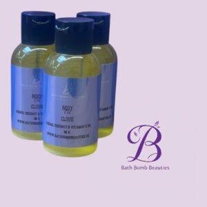 Three yellow bodycare bottles with blue caps and labels, arranged in front of a lavender background with a Bath Bomb Beauties logo to the right.