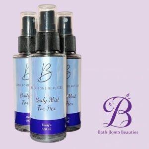 Three bath bomb beauties body mist for her spray bottles with blue gradient labels arranged against a light purple background and brand logo nearby