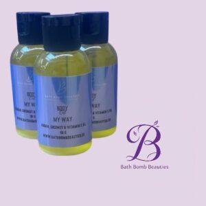 Three yellow bottles with blue labels and dark blue caps, arranged on a light purple background beside the Bath Bomb Beauties logo.