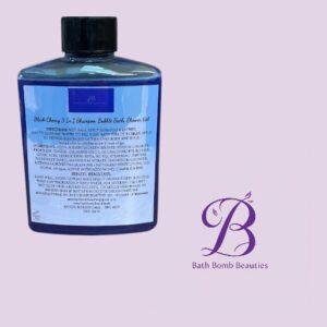 Blue bottle of Bath Bomb Beauties Black Cherry 3-in-1 shampoo, conditioner, and body wash, set against a light purple background with the Bath Bomb Beauties logo.