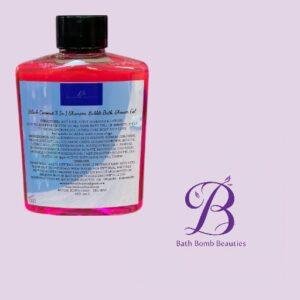 Pink bottle of bath product with black cap and labeled front, placed on a light purple background beside the Bath Bomb Beauties logo.