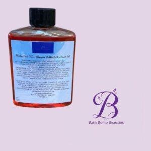 Clear square bottle of red liquid with a black cap and blue label, placed on a light purple background beside the Bath Bomb Beauties logo.
