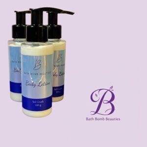 Three Bath Bomb Beauties body lotion bottles with pump tops on a lilac background, featuring a purple BB logo in the corner.