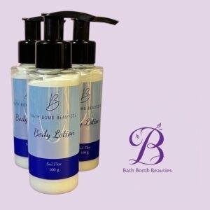 Three pump bottles labeled Bath Bomb Beauties Body Lotion set against a light lavender background with the brand logo nearby.