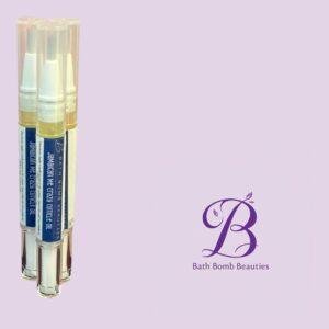 Three cuticle oil spray tubes labeled Jamaican Me Crazy on a lavender background, with Bath Bomb Beauties logo in the corner.