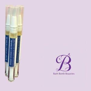 Three clear lip balm tubes with pastel contents clustered on a soft lilac background, Bath Bomb Beauties logo visible in the corner.