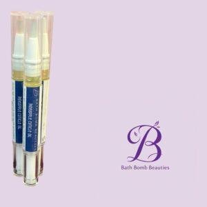 Three spray bottles of pineapple cuticle oil with blue labels, arranged against a light lavender background featuring Bath Bomb Beauties branding.