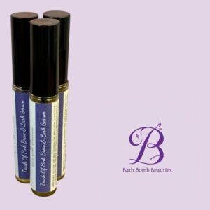 Three purple labeled beauty roll on bottles with black caps standing on the left against a light purple background featuring the bath bomb beauties logo