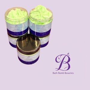 Two jars of bright green Luxurious Whipped Soap from Bath Bomb Beauties on a lavender background