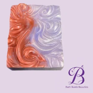 Marbled soap bar with orange and lavender swirls on a pale purple backdrop; Bath Bomb Beauties logo in the corner.