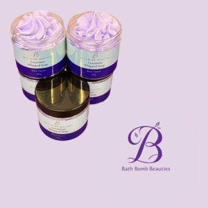 Two jars of lavender whipped soap from Bath Bomb Beauties, set against a pale purple background (labels read 'Luxurious Whipped Soap').