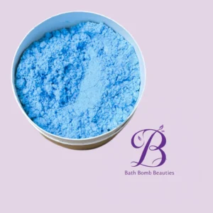Blue bath bomb powder in a round white container on a lavender background with bath bomb beauties logo