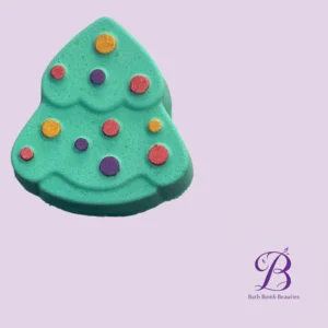 Teal, tree-shaped bath bomb with multicolored dots on a lavender background. (Currently showing brand watermark in corner.)
