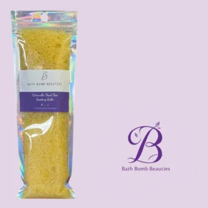 Holographic zip pouch of bath bomb beauties citronella dead sea soaking salts on a lavender background with a purple logo