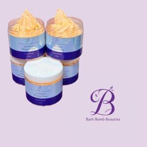 Two jars of Luxurious Whipped Soap with orange whipped topping, blue labels, on a lavender background.