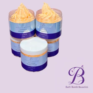 Two blue-labeled jars of Luxurious Whipped Soap with peach whipped cream tops, set against a lavender background.