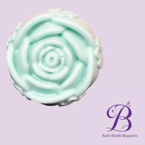 Mint-green bath bomb swirl on lavender background with Bath Bomb Beauties logo in purple script on the bottom right.