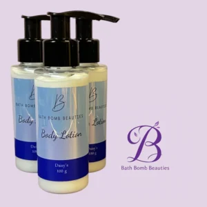 Three Bath Bomb Beauties body lotion bottles with black pump tops on a lavender background, logo to the right.