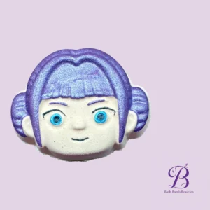 Close up of a purple bath bomb face with blue eyes on a lavender background with a bath bomb beauties logo in the bottom right corner  oopslets correct