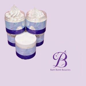 Two jars of Luxurious Whipped Soap by Bath Bomb Beauties with white whipped cream topping on a lavender backdrop.