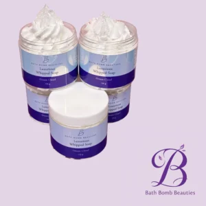 Two jars of Bath Bomb Beauties Luxurious Whipped Soap in Dream Cloud scent on a lavender background.