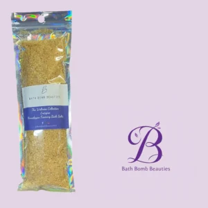 Holographic bag of Himalayan foaming bath salts labeled 'Bath Bomb Beauties' against a light purple background with a decorative logo.