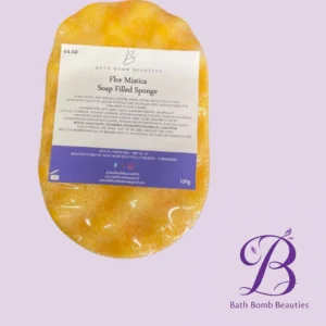 Flor Mistica Soap Filled Sponge by Bath Bomb Beauties on a lavender background with brand logo