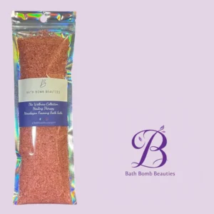 Holographic plastic pouch of pink himalayan bath salts with a white label and purple branding that reads bath bomb beauties