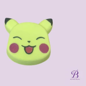Yellow smiling character head with closed eyes, pink cheeks, and a small tongue showing, on a lavender background (Bath Bomb Beauties logo in corner).