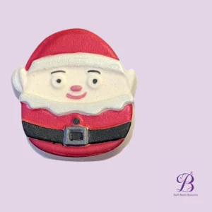 Santa Claus-themed bath bomb with red suit and white trim on a lavender background.