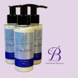 Three Bath Bomb Beauties body lotion bottles with pump tops against a lavender background, logo visible.