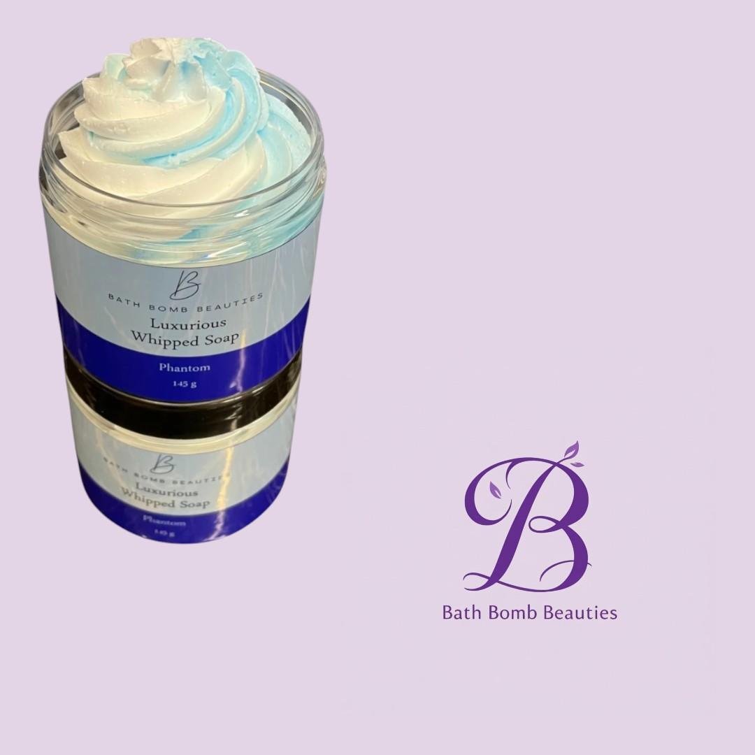 Phantom whipped soap bath bomb beauties Jar of bath bomb beauties luxurious whipped soap with white and blue swirl set against a lavender background with a purple logo on the right