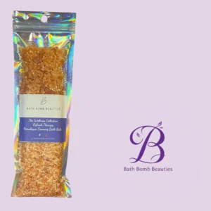 Holographic bagged bath salts from bath bomb beauties labeled himalayan framing bath salts on a lilac background with their purple logo nearby