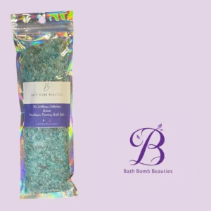 Package of bath bomb beauties bath salts containing blue green crystals on a holographic pouch with brand label and purple logo in the background