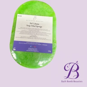 Green oval bath bomb with a white label reading 'Sol Cabana Soap Filled Sponge' on a lavender background; purple Bath Bomb Beauties logo in the bottom-right corner.