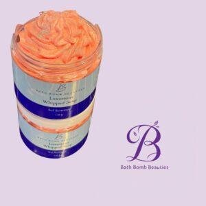 Jar of peach Luxurious Whipped Soap by Bath Bomb Beauties, with a purple logo on a lavender background.