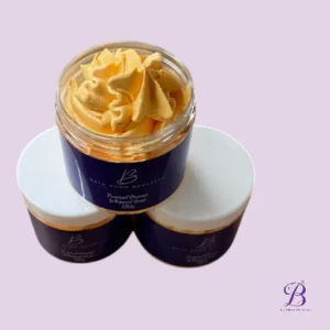 Three jars with purple labels on a light purple background; the open jar shows orange piped frosting.