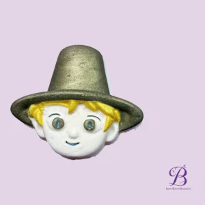 Partial cartoon snowman with a glittery black top hat on a lavender background bath bomb beauties logo appears bottom right