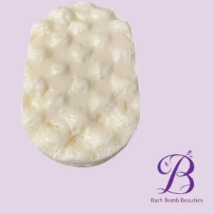 White oval bath bomb with a bumpy surface on a lavender background purple bath bomb beauties logo in the bottom right