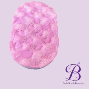Pink bath bomb with a bubbled surface on a light purple background, featuring a purple Bath Bomb Beauties logo in the bottom right.
