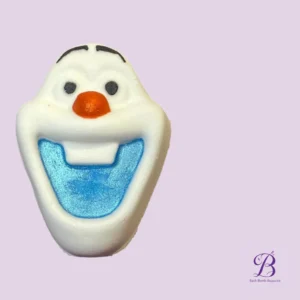 Close-up of a white snowman soap with an orange nose and blue open mouth, set against a lilac background; Bath Bomb Beauties logo bottom right.