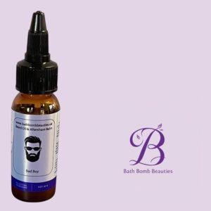 Amber glass bottle with a dropper cap labeled bad boy beard oil from bath bomb beauties against a light purple background with a purple bb logo