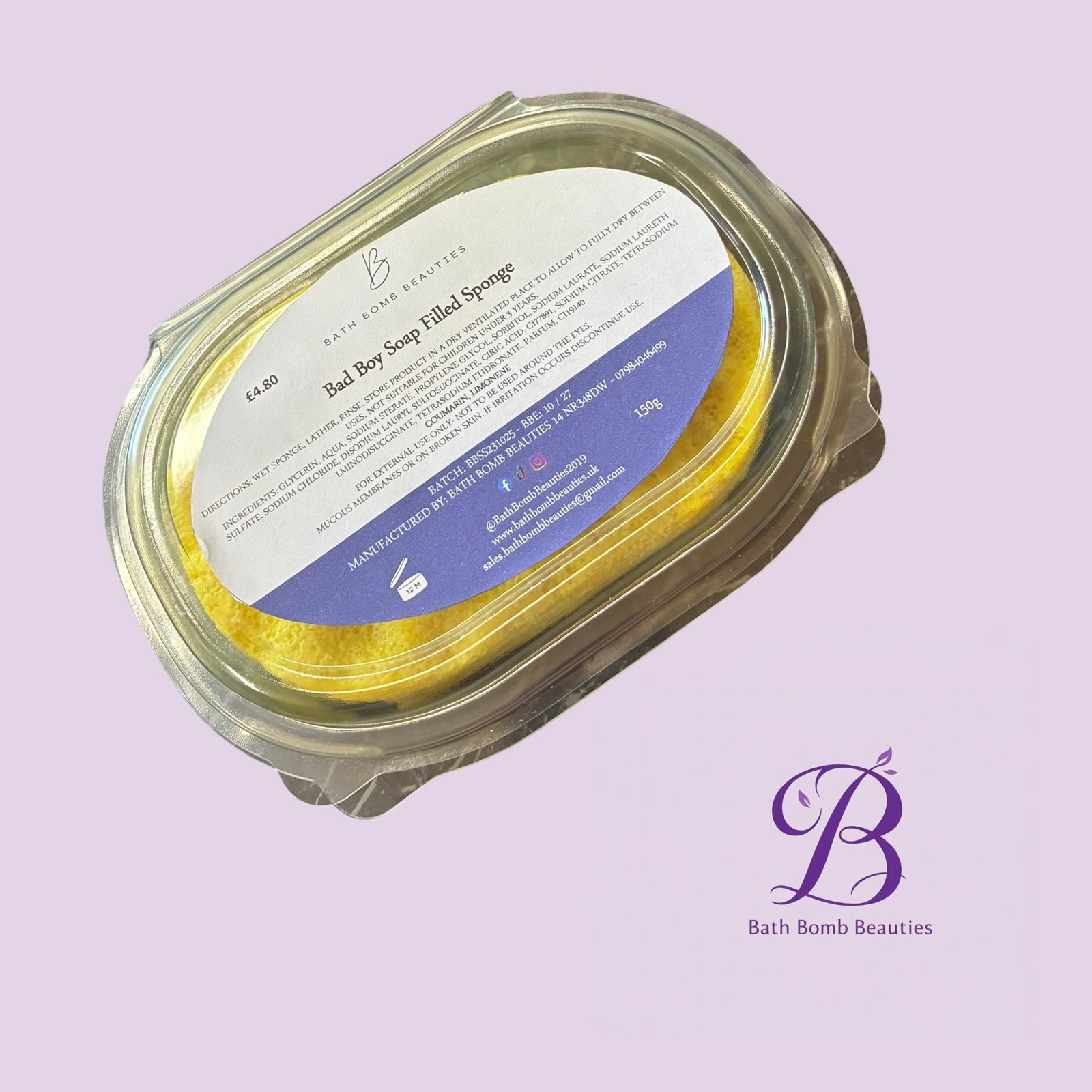 Bad boy exf bath bomb beauties Close up of a glass jar containing a yellow bath bomb with a white label that reads bath bomb beauties on a lavender background