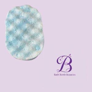 Pastel lavender background with a blue and white bubbly bath bomb on the left and the bath bomb beauties logo on the right