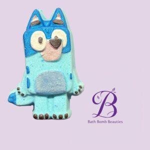 Cartoon blue dog statue against a lavender background with the bath bomb beauties logo text to the right