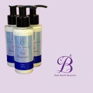 Three pump bottles of Face Moisturiser from Bath Bomb Beauties set against a pale lavender background with a purple logo in the corner.