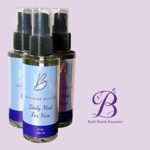 Three fragrance spray bottles with dark caps, labeled Bath Bomb Beauties Body Mist for Him, set against a lavender background with a purple Bath Bomb Beauties logo.