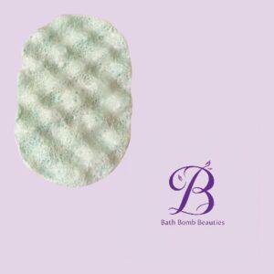 Light green textured bath bomb on a pale lavender background beside the Bath Bomb Beauties logo.