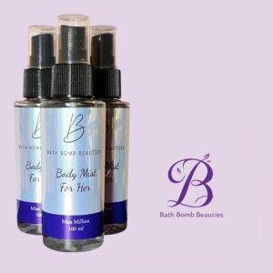 Three bath bomb beauties body mist bottles with light blue labels and black spray caps shown against a lavender background with a purple logo